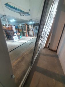 Silver Aluminium Bi-Fold Door With Outside Access Door