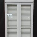 Wooden bi-fold door with awning toplight and shutters