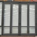 Tall Ironsand aluminium bi-fold door with windows