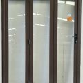 Brown aluminium bi-fold with dedicated door