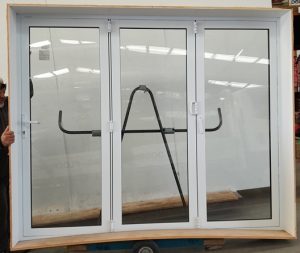 White double glazed bi-fold with dedicated door