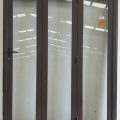Brown aluminium bi-fold with dedicated door