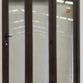 Brown aluminium bi-fold with dedicated door