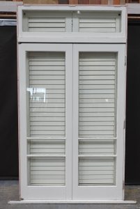 Wooden bi-fold door with awning toplight and shutters