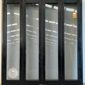 Black aluminium bi-fold door with pet door