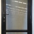 Black aluminium door with pet access