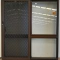 Dark bronze aluminium sliding door with security screen